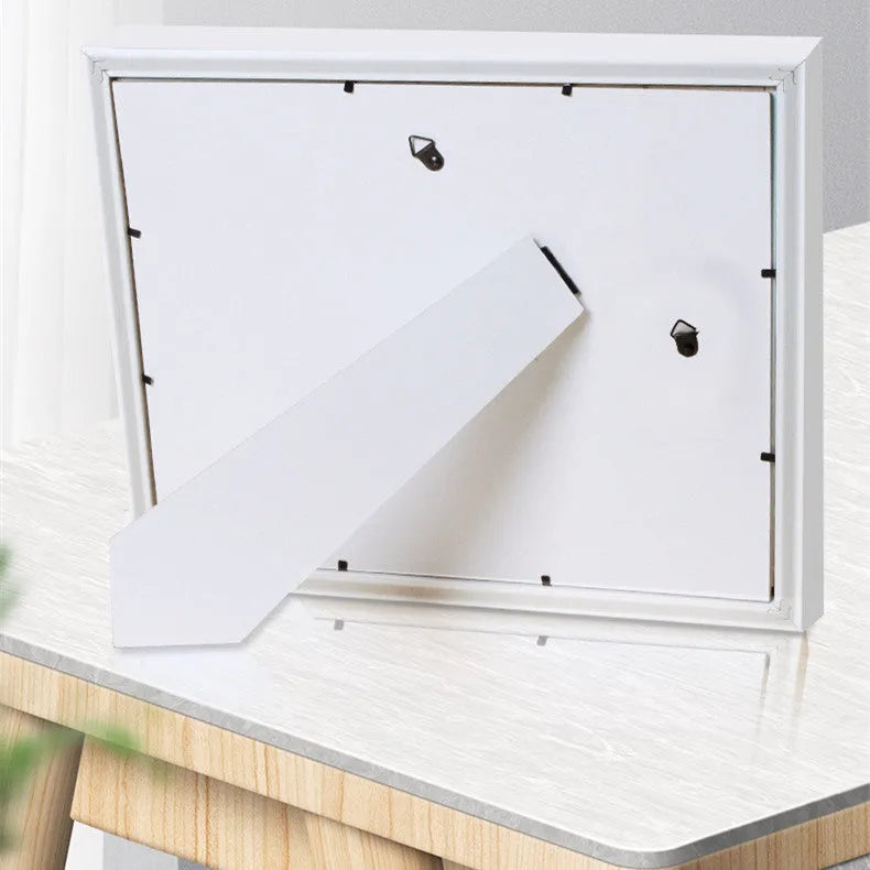 Modern DIY baby hand and foot print anniversary frame in white with optional warm LED lights.
