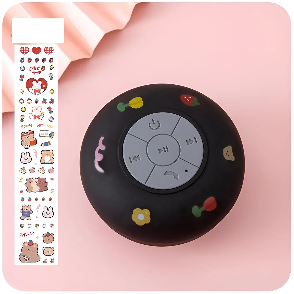 Small colourful silicone Bluetooth speaker with a rubber suction cup on its base.