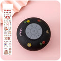 Small colourful silicone Bluetooth speaker with a rubber suction cup on its base.