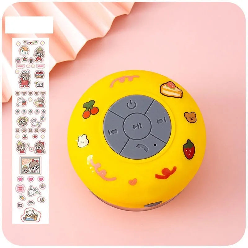 Small colourful silicone Bluetooth speaker with a rubber suction cup on its base.