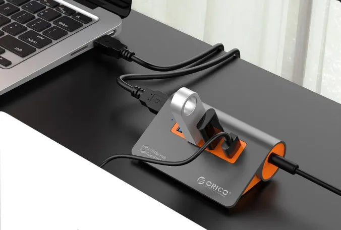 Dark grey and orange aluminium USB 3.1 laptop hub with four ports and separate 100cm cable