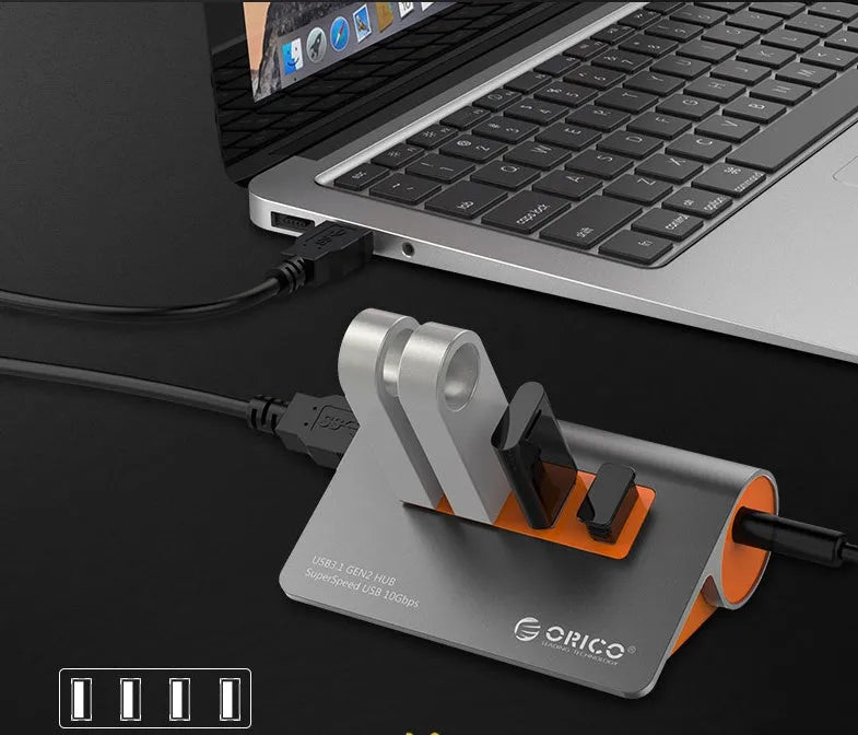 Dark grey and orange aluminium USB 3.1 laptop hub with four ports and separate 100cm cable
