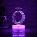 3D LED night light projecting diamond ring design with colour-changing illumination on bedside table