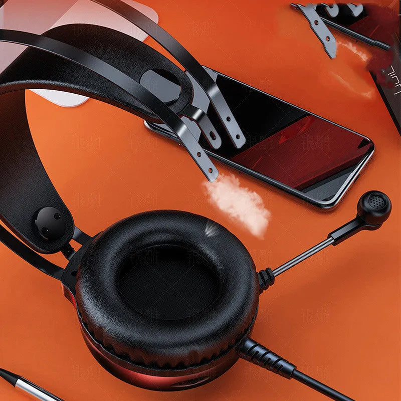 Black wired over-ear computer headset with microphone and 3.5mm plug on a desk
