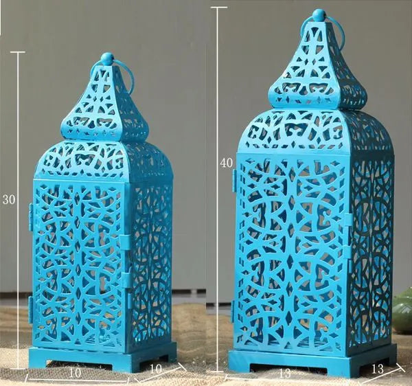 Geometric iron Moroccan lantern measuring 14x14x38cm with hollow design and candlestick holder