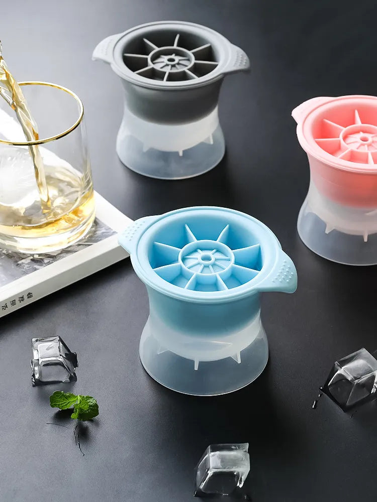 Silicone ice tray with hockey puck and geometric moulds in light grey, blue, and pink colours for large ice cubes