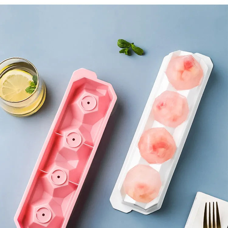 Silicone ice tray with hockey puck and geometric moulds in light grey, blue, and pink colours for large ice cubes