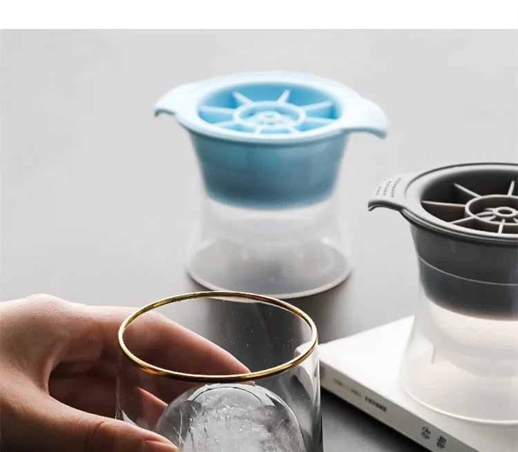 Silicone ice tray with hockey puck and geometric moulds in light grey, blue, and pink colours for large ice cubes