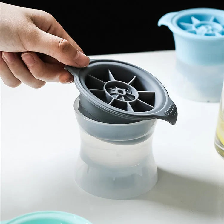 Silicone ice tray with hockey puck and geometric moulds in light grey, blue, and pink colours for large ice cubes