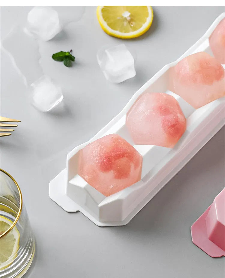Silicone ice tray with hockey puck and geometric moulds in light grey, blue, and pink colours for large ice cubes