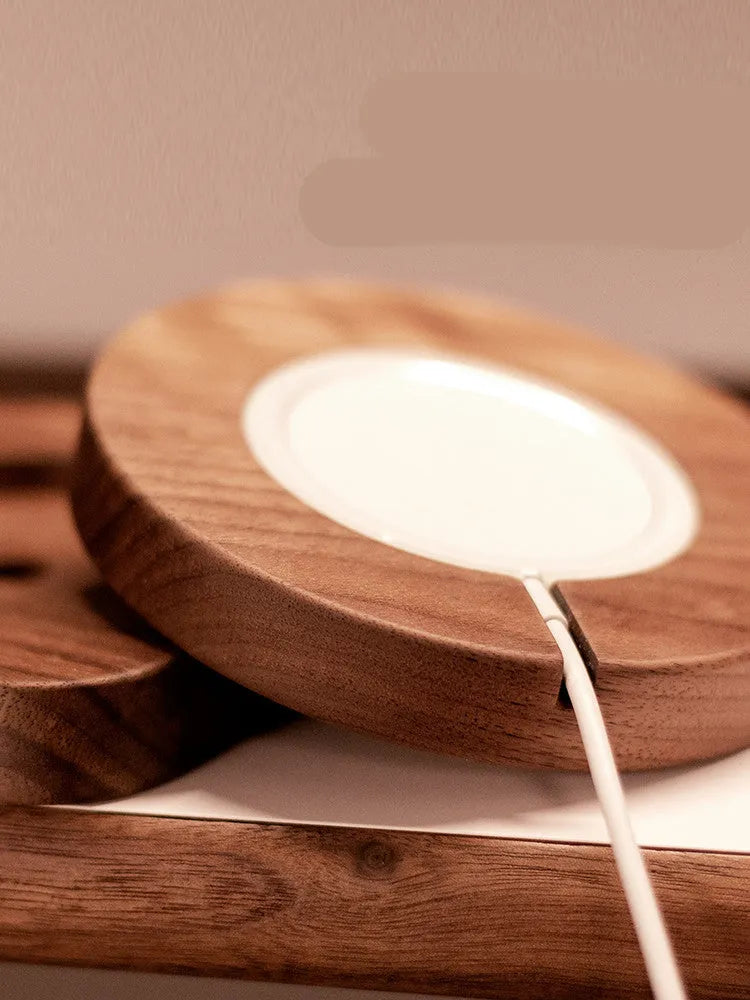 Solid walnut wood magnetic wireless charger bracket base with 15W fast charging, shown in round and square sections on a desk