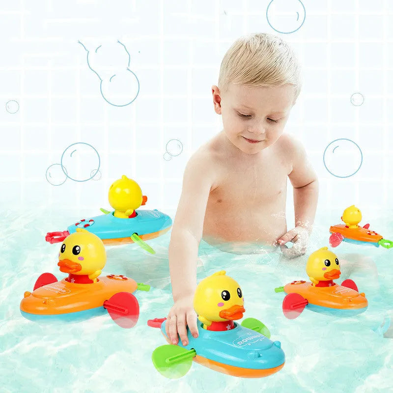 Yellow plastic wind-up swimming bath toy for children on a blue background.