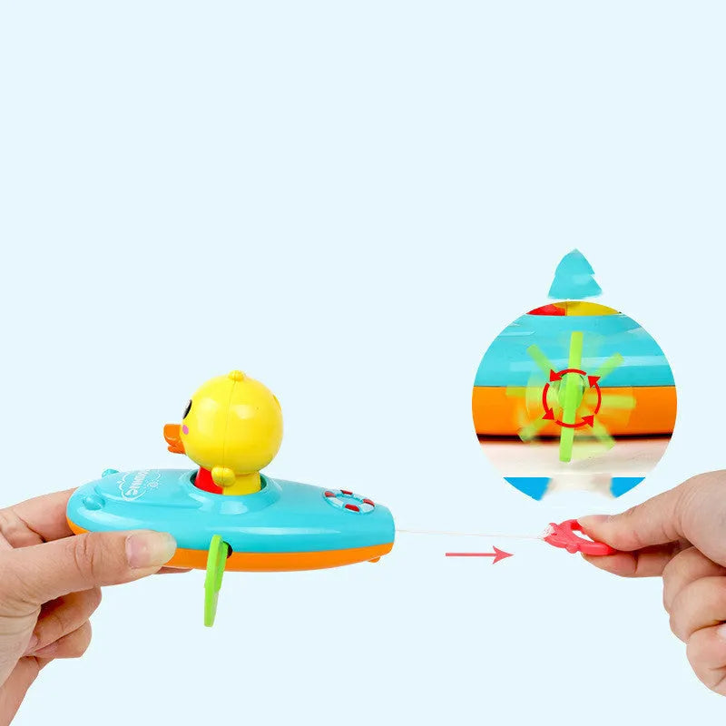 Yellow plastic wind-up swimming bath toy for children on a blue background.