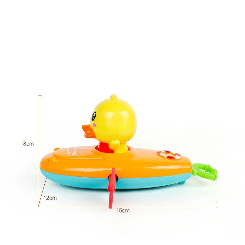 Yellow plastic wind-up swimming bath toy for children on a blue background.
