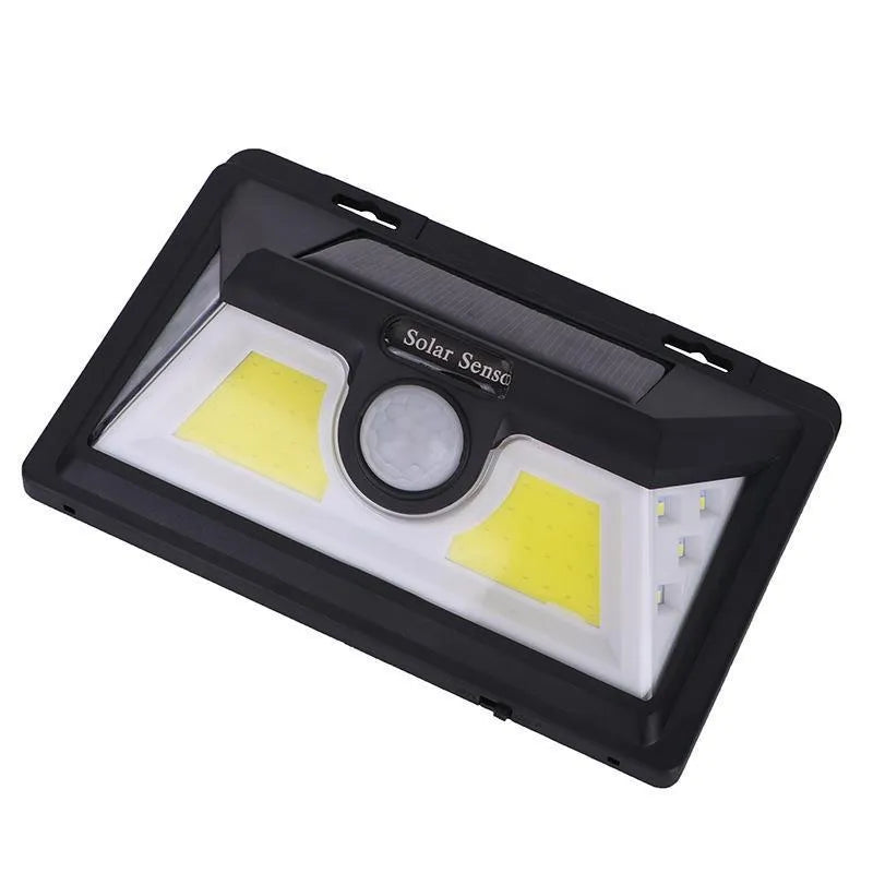 Solar-powered outdoor garden lamp with LED lights and a motion sensor on a stake.
