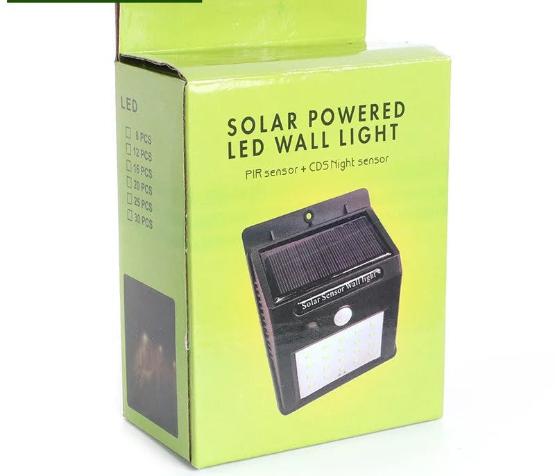 Solar-powered outdoor garden lamp with LED lights and a motion sensor on a stake.