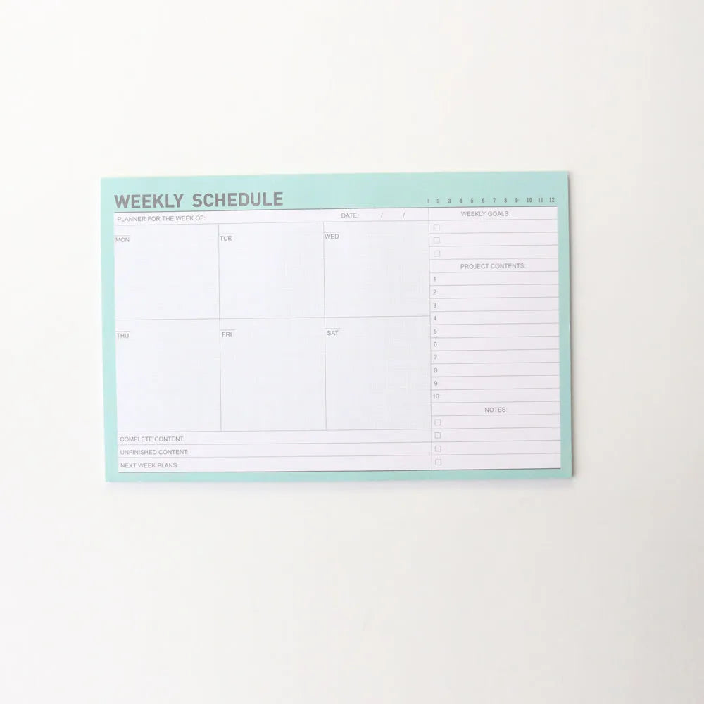 Domikee desk notepad organiser showing pink and green mixed cover with weekly, monthly, today, and memo planning sections