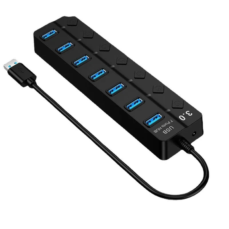 Black 7-port USB 3.0 hub with external power adapter on desk