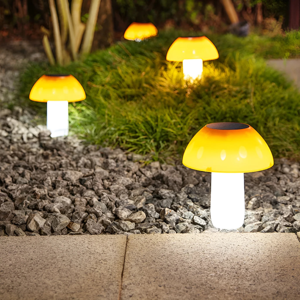 Solar-powered mushroom-shaped garden light with ground spike for lawn or border insertion.
