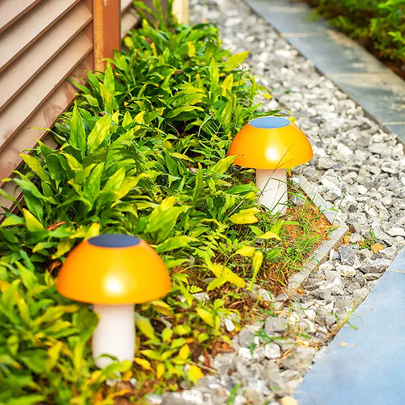 Solar-powered mushroom-shaped garden light with ground spike for lawn or border insertion.