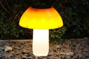 Solar-powered mushroom-shaped garden light with ground spike for lawn or border insertion.