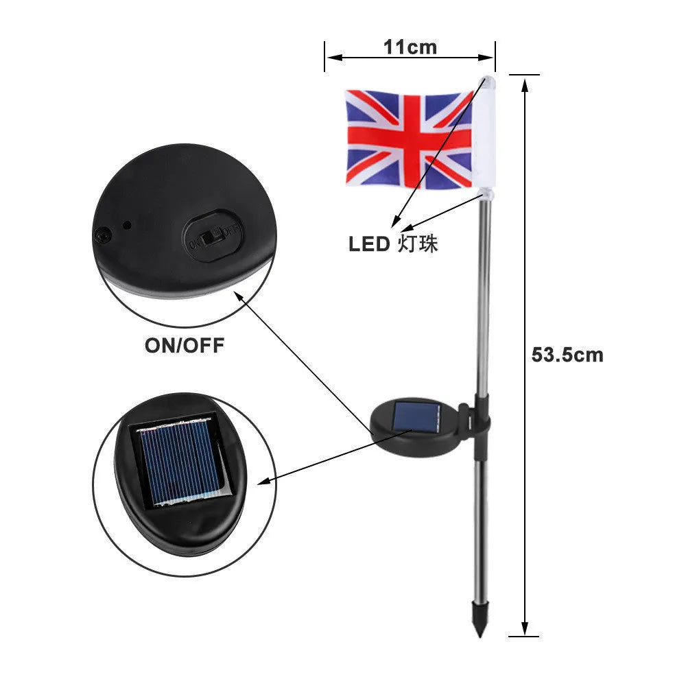 Solar-powered garden flag light with a stainless steel pole displaying a British flag design at night.