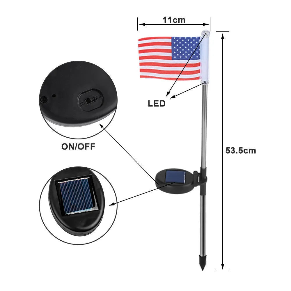 Solar-powered garden flag light with a stainless steel pole displaying a British flag design at night.
