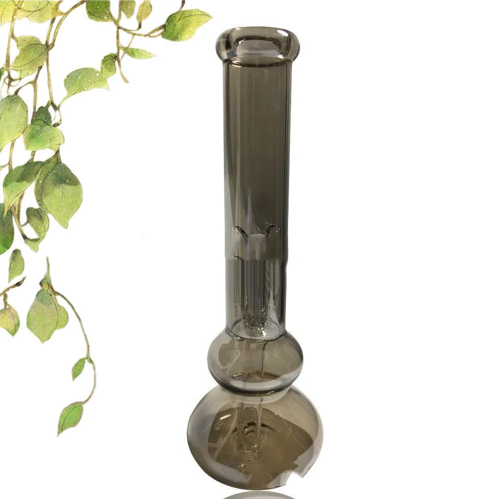 Clear glass vase with geometric design on wooden table, holding pink flowers