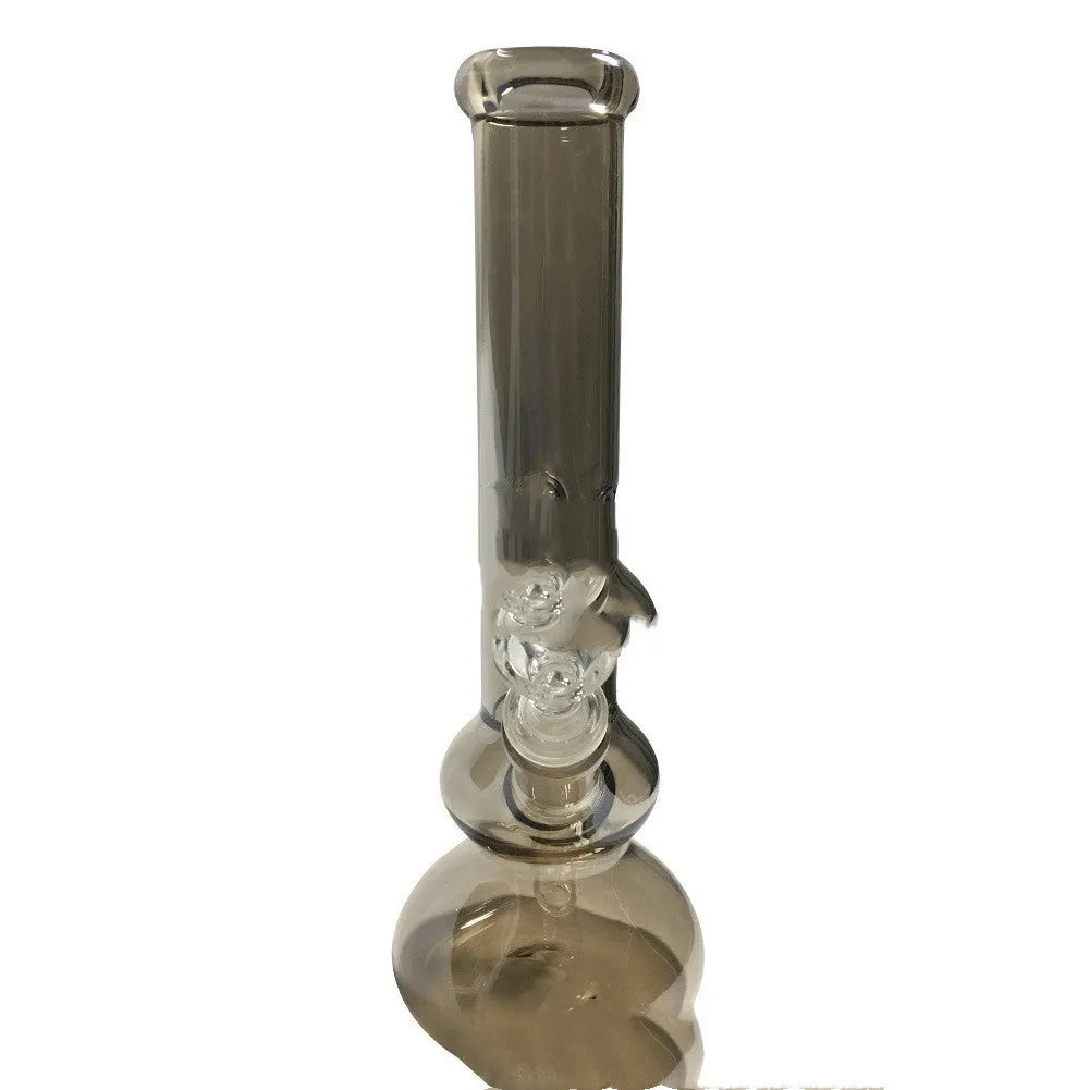Clear glass vase with geometric design on wooden table, holding pink flowers