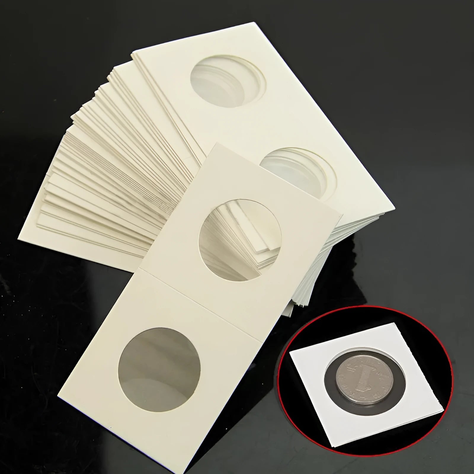 Set of 50 white paper coin protectors in a clear plastic OPP bag for commemorative coin collection.