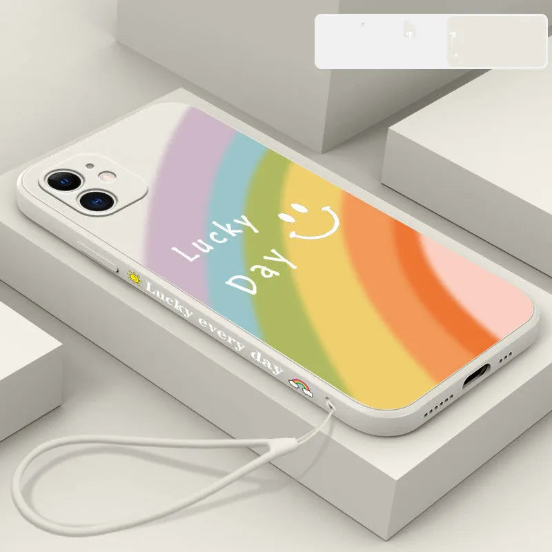 Rainbow smiley face printed on a colourful silicone phone case for iPhone, showing straight-edge design.
