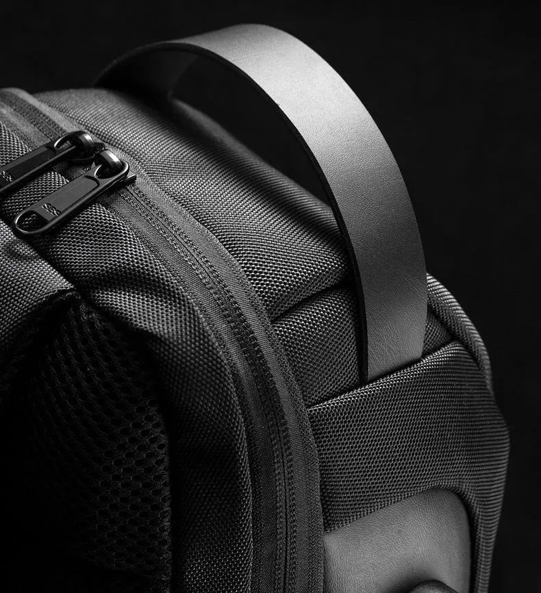 Men's canvas chest shoulder bag showing square shape, zipper, and internal phone and document organisers.