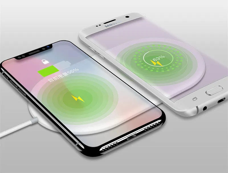 White dual wireless charger charging two mobile phones on a minimalist pad
