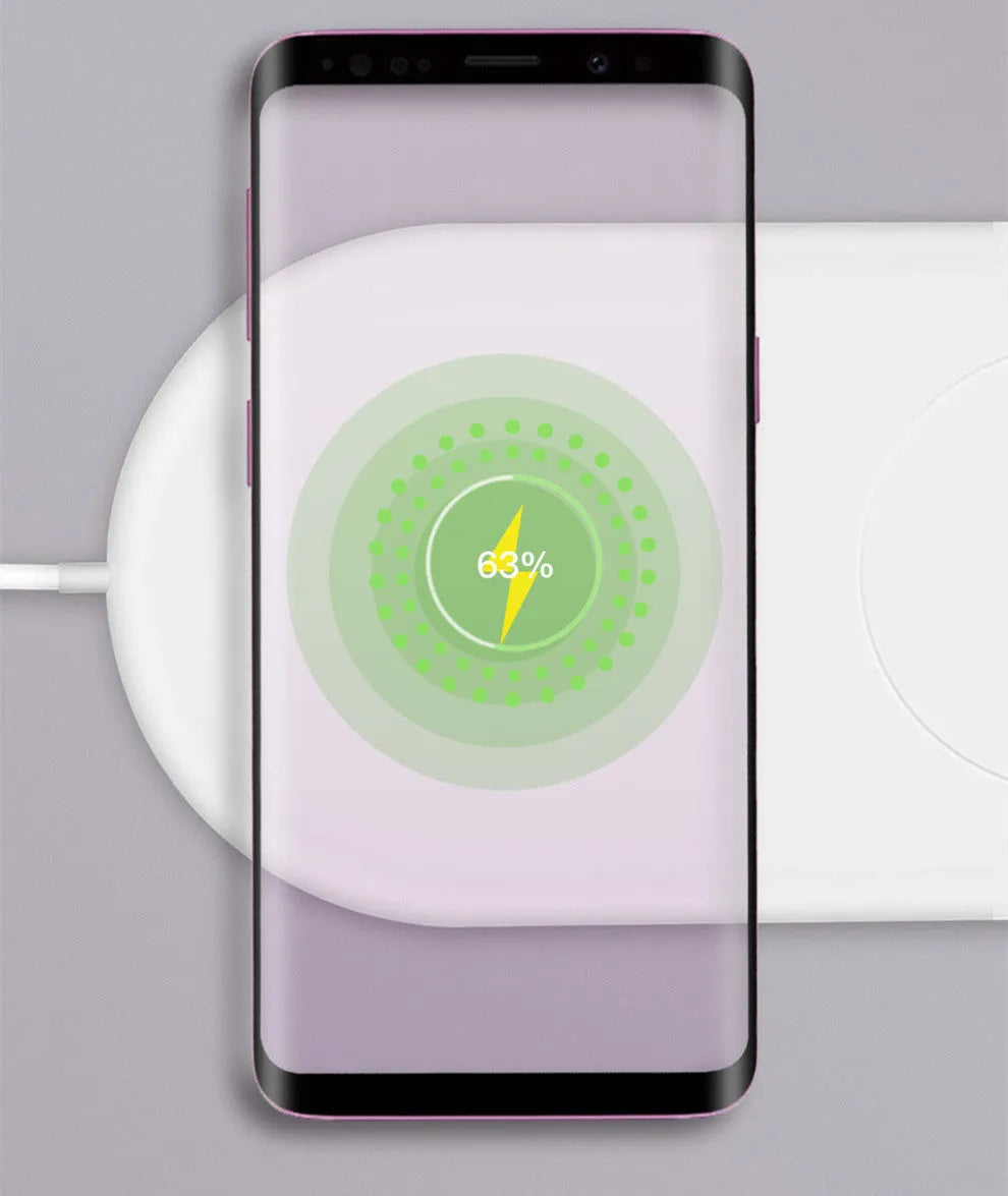 White dual wireless charger charging two mobile phones on a minimalist pad