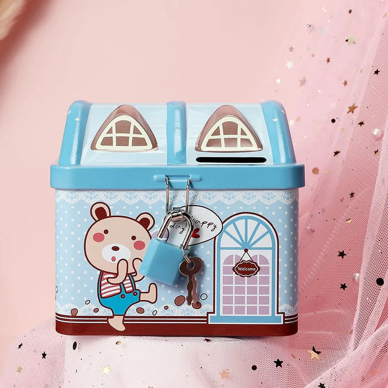Blue house-shaped tinplate piggy bank for coins on a wooden desk