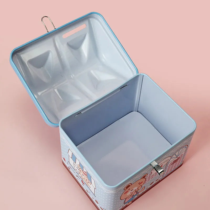 Blue house-shaped tinplate piggy bank for coins on a wooden desk