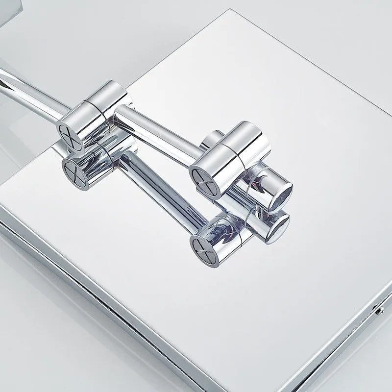 Stainless steel wall-mounted folding bathroom mirror with built-in lamp in a choice of four metallic finishes.
