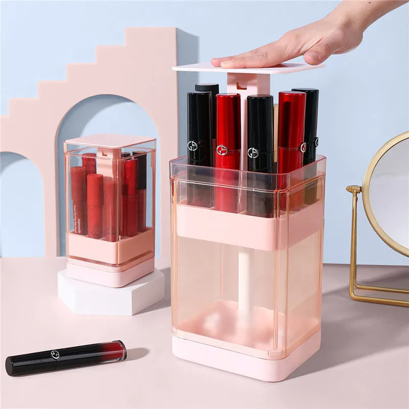 White press-lift lipstick storage box with dust cover open, showing 12 slots on a desktop.