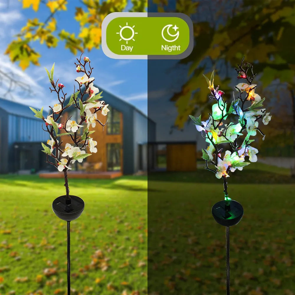 Solar-powered cherry blossom string lights with ground spike for outdoor garden decoration.