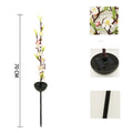 Solar-powered cherry blossom string lights with ground spike for outdoor garden decoration.