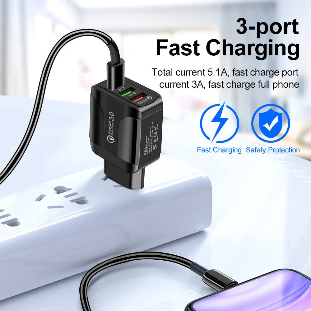 Black fast charge travel charger with 3 USB ports and a UK three-pin plug