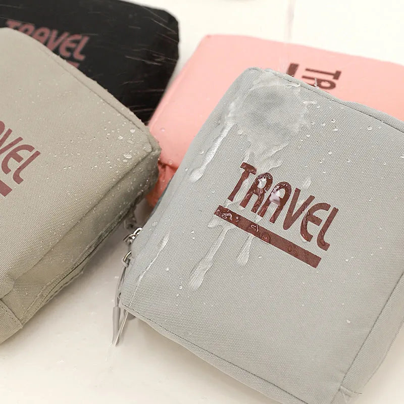Cube-shaped travel storage bag in black colour with seal closure, showing 300D Oxford cloth texture and dimensions