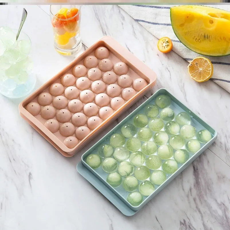 Sky blue and pink 3D round ice ball mould trays with 18 and 33 grid options for home bar use.