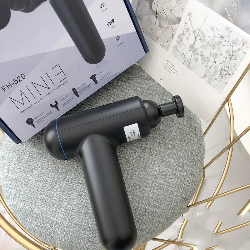 God Fascia Gun handheld percussion muscle massager in grey colour with USB charging port visible