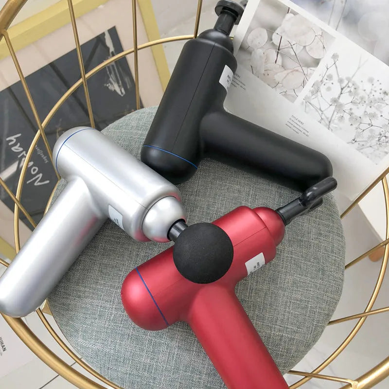 God Fascia Gun handheld percussion muscle massager in grey colour with USB charging port visible