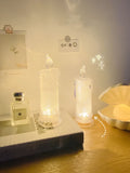 LED bedside lamp with a white message board and erasable pen next to it on a bedside table.