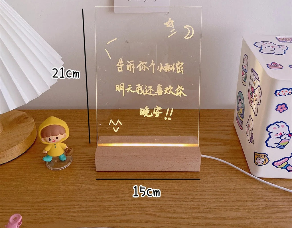 LED bedside lamp with a white message board and erasable pen next to it on a bedside table.
