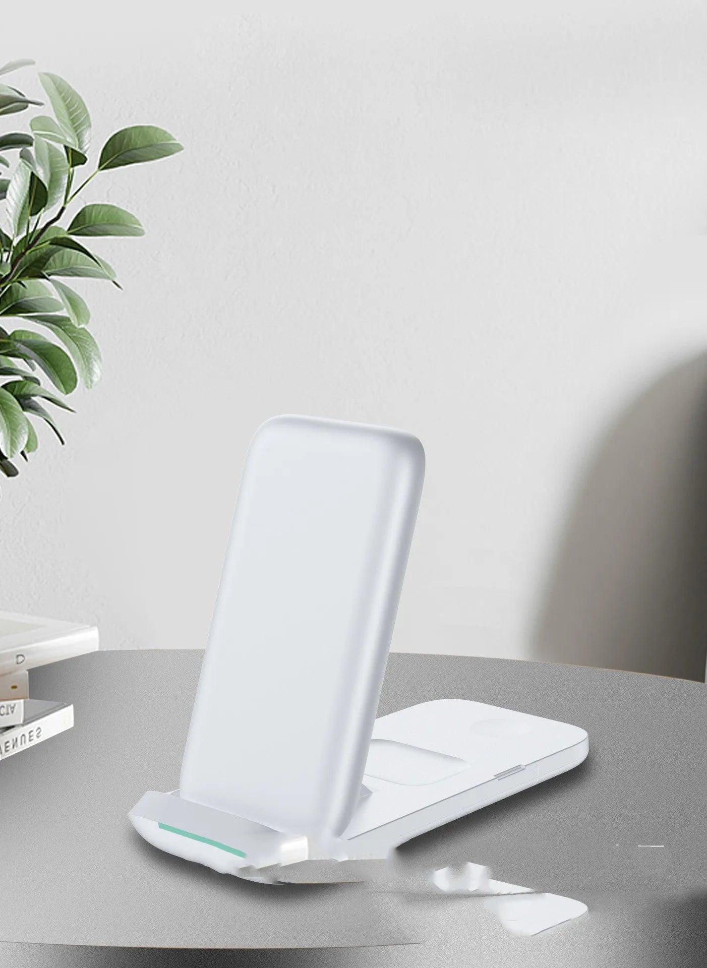 Black foldable three-in-one wireless charger open showing pads for two phones and an Apple Watch.