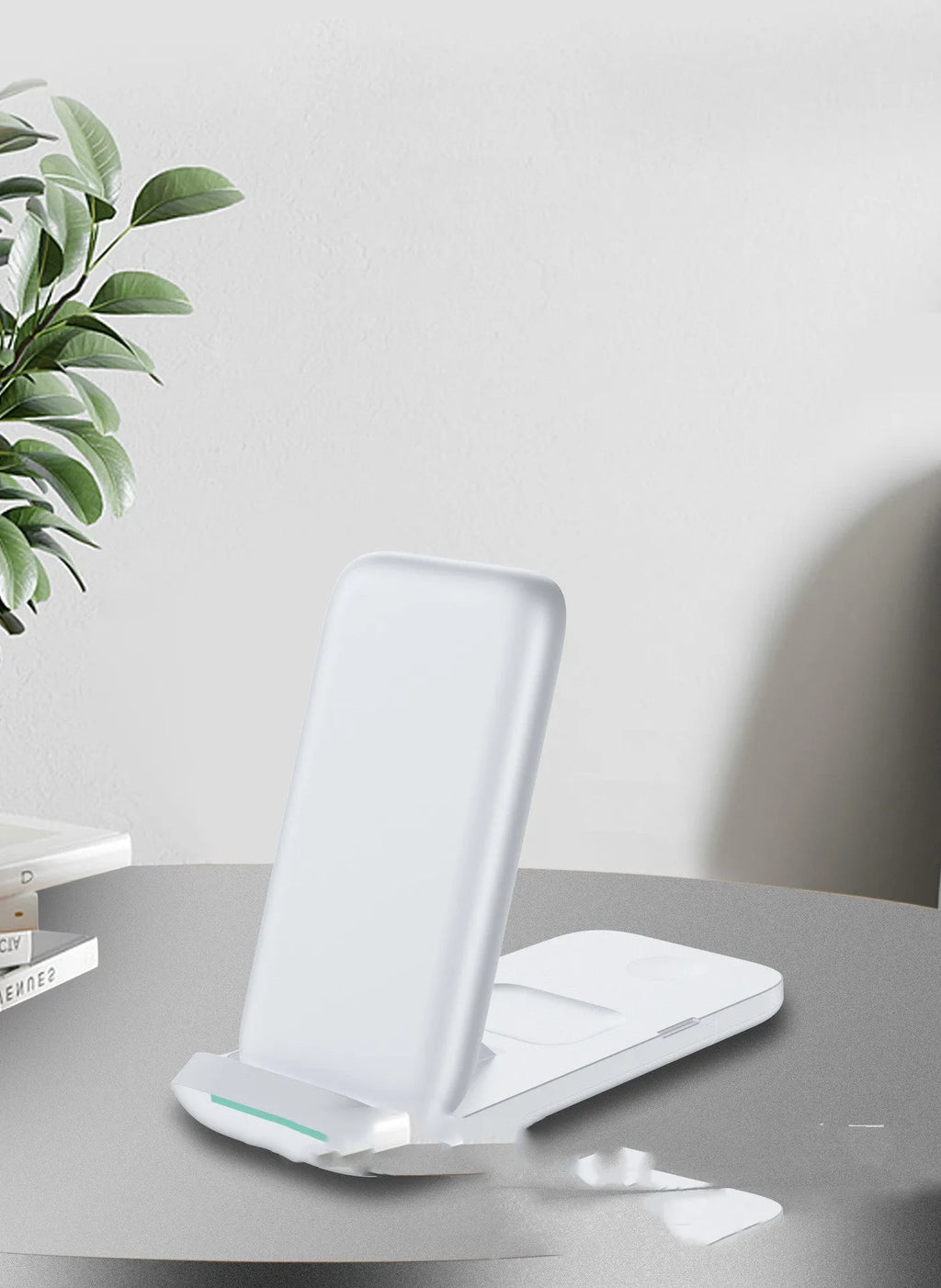 Black foldable three-in-one wireless charger open showing pads for two phones and an Apple Watch.