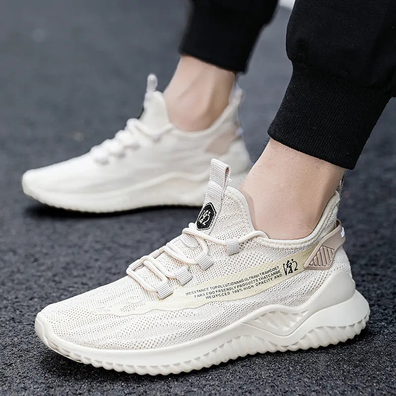 Men's white mesh sports shoes with rubber sole and round toe design on neutral background